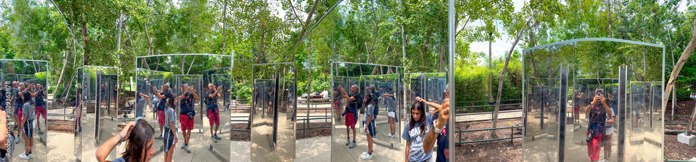 Obraz premium Multiple mirrors reflections with people in a city park