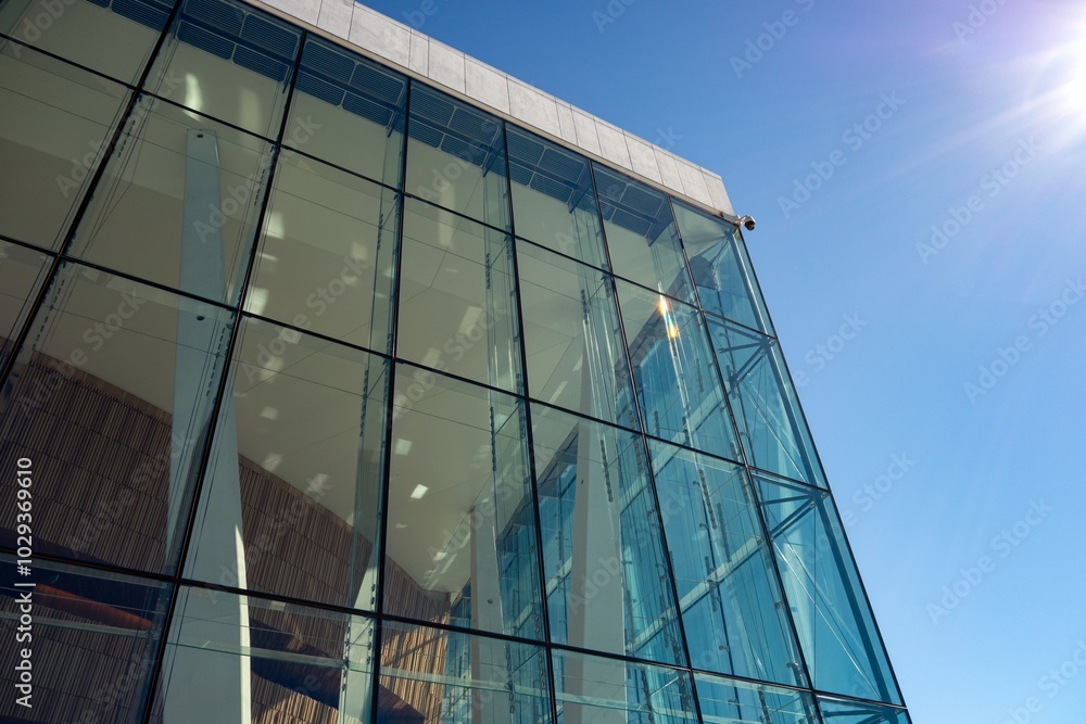 Obraz premium Exterior of Oslo Opera (Operataket) building, support columns and window, sun flare