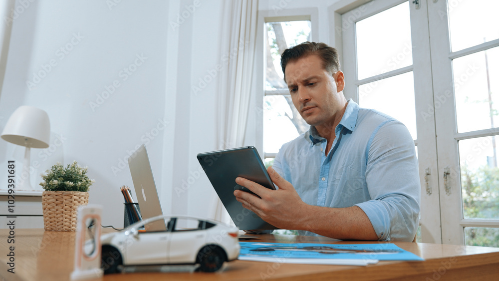 Stressed and frustrated car design engineer put his head in his hand after discover flaw in vehicle design, working at home for automotive business while trying to find solution. Synchronos Stressed and frustrated car design engineer put his head in his hand after discover flaw in vehicle design, working at home for automotive business while trying to find solution. Synchronos