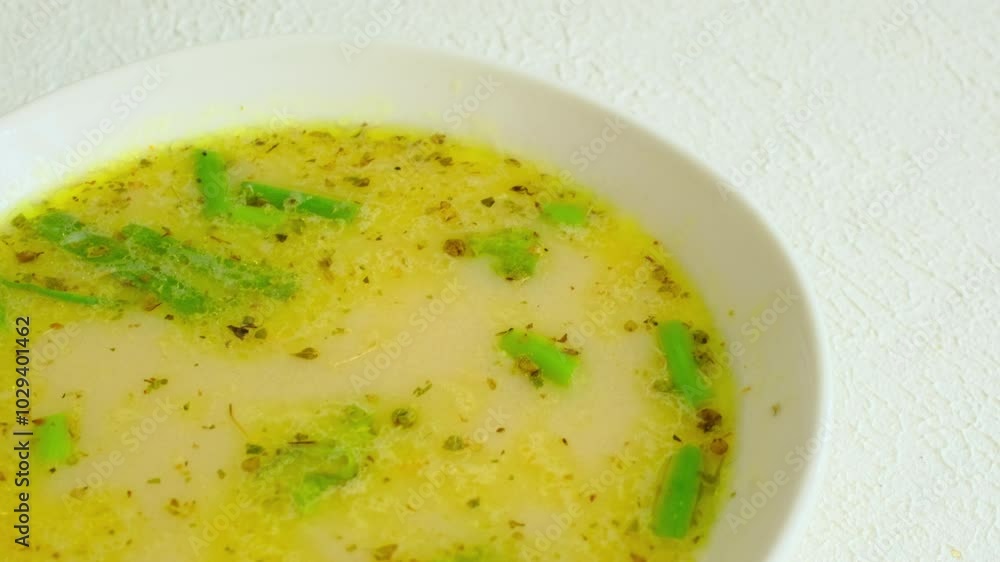 fish soup with vegetables and lemon in white bowl close-up fish soup with vegetables and lemon in white bowl close-up