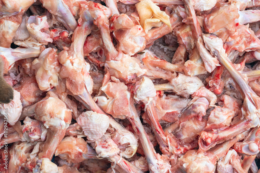 Raw chicken bones, production leftovers. Background texture Raw chicken bones, production leftovers. Background texture