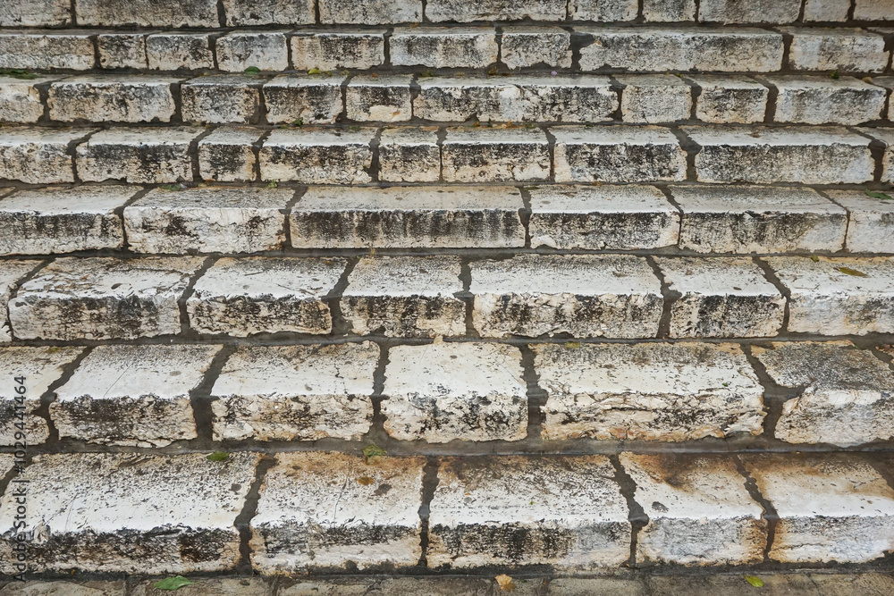 Ancient stone stairs texture. Worn, weathered blocks leading upward. Old urban architectural design. Historic stairway background. Aged stone stepway pattern. Rustic stair background. Ancient stone stairs texture. Worn, weathered blocks leading upward. Old urban architectural design. Historic stairway background. Aged stone stepway pattern. Rustic stair background.