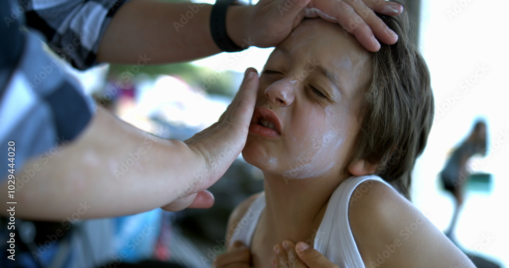 Sunscreen being spread on a child's face in slow motion at 800 fps, highlighting the detailed care and protection given during sunny outdoor activities Sunscreen being spread on a child's face in slow motion at 800 fps, highlighting the detailed care and protection given during sunny outdoor activities