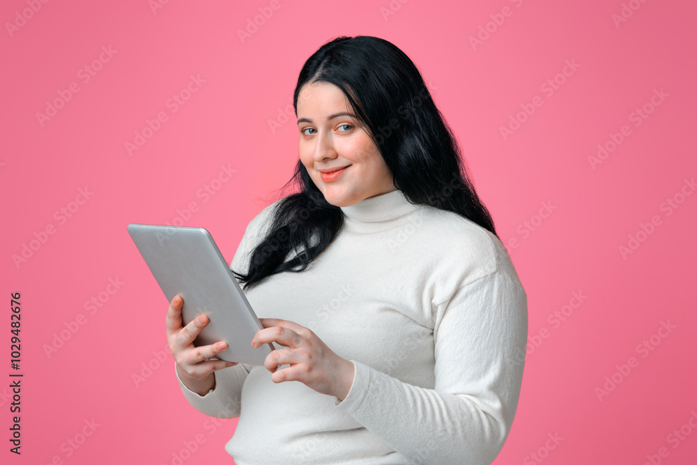 Online Shopping For Plus Size People. Smiling Overweight Woman Holding Digital Tablet, Ordering Clothes In Internet, Isolated On Pink Background Online Shopping For Plus Size People. Smiling Overweight Woman Holding Digital Tablet, Ordering Clothes In Internet, Isolated On Pink Background