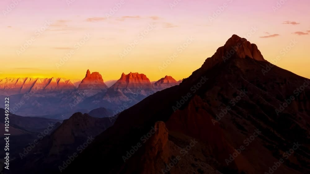 Majestic mountain peaks glowing in the warm light of the setting sun, creating a breathtaking spectacle of nature's beauty Majestic mountain peaks glowing in the warm light of the setting sun, creating a breathtaking spectacle of nature's beauty