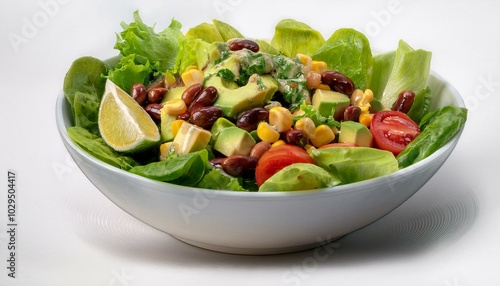 A bowl filled with romaine lettuce, black beans, corn, diced tomatoes, avocado, and a cilant photo