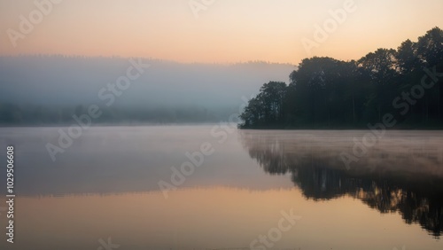 Soft morning fog hovering over a tranquil lake, reflecting the silhouette of distant trees. This peaceful scene blends the stillness of water with the mystique of fog in a natural, quiet setting