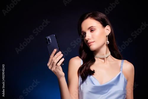 Photo of attractive girl browsing cell smart gadget isolated dark color background