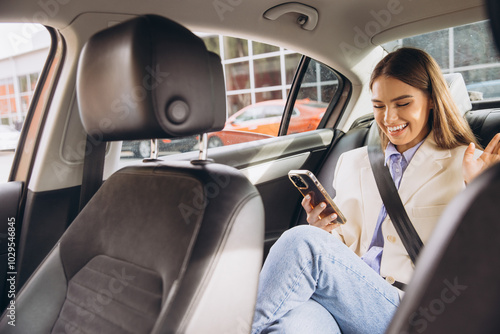 Smiling Woman Using Smartphone in Car During Video Call