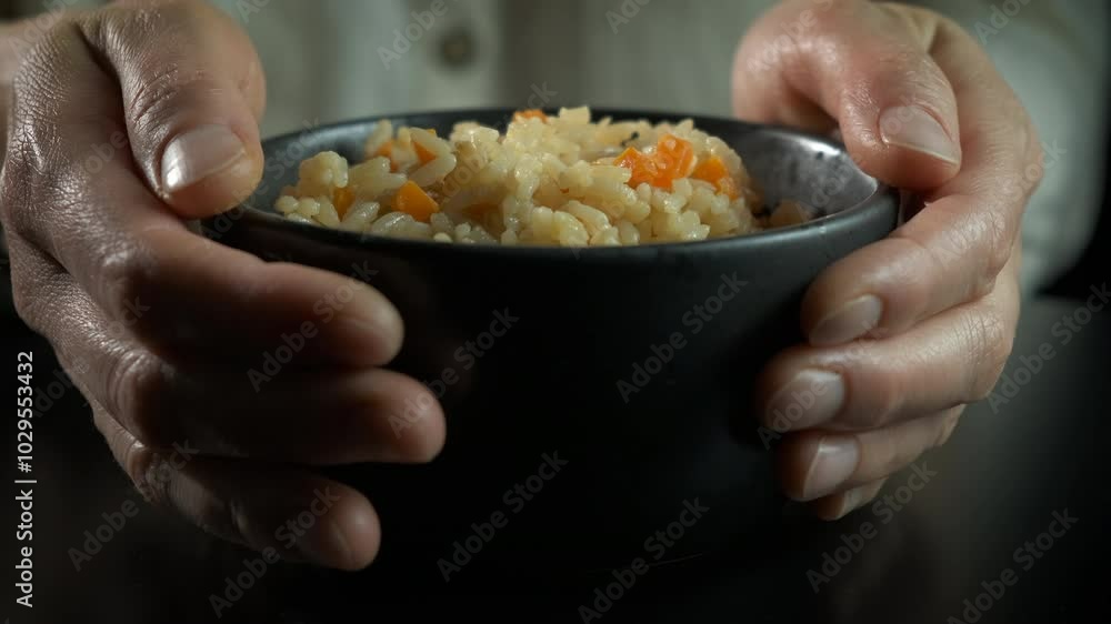 Female food for charity during crisis. A female hands enjoy the charity food in the bowl against black background. Female food for charity during crisis. A female hands enjoy the charity food in the bowl against black background.
