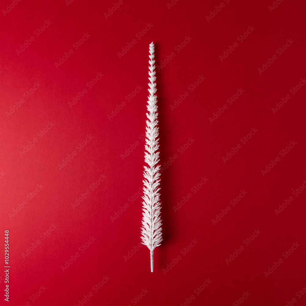 Christmas tree made of white pine tree branches on red backdrop. Minimal New Year or Christmas background concept. Christmas tree made of white pine tree branches on red backdrop. Minimal New Year or Christmas background concept.