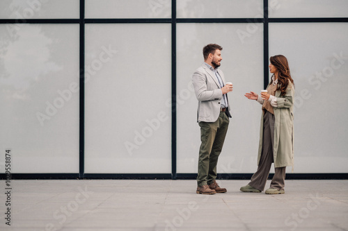 Obraz na plátně Business people having coffee break chatting outside office building