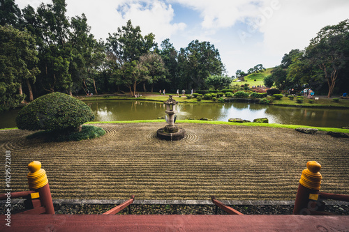 Tranquil garden view featuring a central fountain and manicured landscapes in a serene park setting during daylight hours