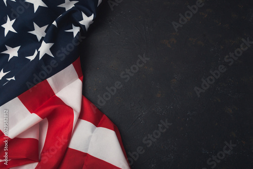 A red and white American flag is draped over a black background
