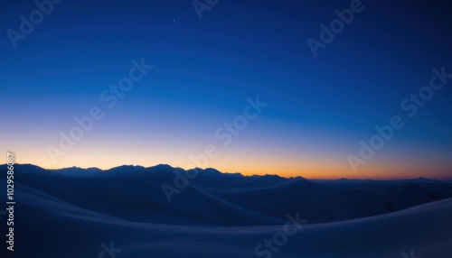 a view of a mountain range with a blue sky and a few clouds, blue hour