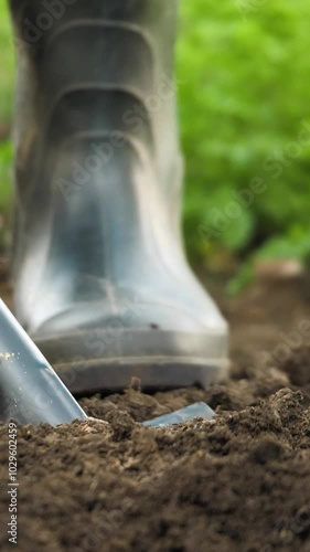 Wallpaper Mural farmer digging soil garden field, agriculture farm, organic gardening techniques, garden soil preparation, outdoor gardening activity, garden tool usage, vegetable garden planting, home gardening Torontodigital.ca