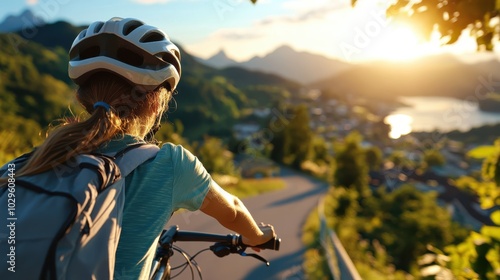 A cyclist rides along a scenic mountain path at sunset, enjoying panoramic views and fresh air, embodying outdoor adventure and freedom, with a clear, sunny sky. photo