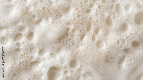 a close-up, top-down view of smooth, fine soap bubbles covering the entire surface in a soft, even layer