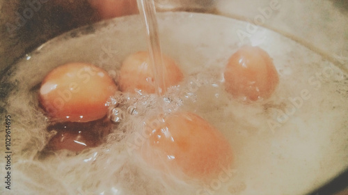 a close-up view of several donuts frying in hot, bubbling oil