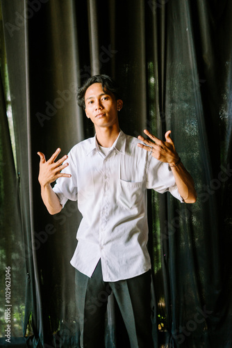 A Southeast Asian man showing a number with his fingers