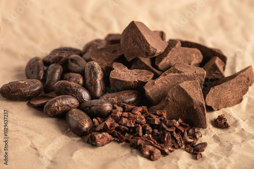 Group of cocoa. Cocoa beans, cocoa mass ,cocoa nips on brown paper background. photo