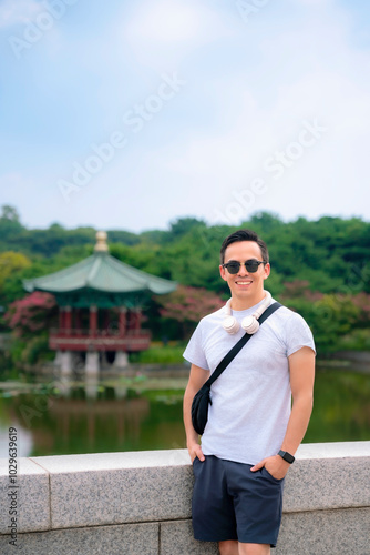 Young smiling Latino in casual outfit outside National Museum of Korea, Seoul, South Korea.