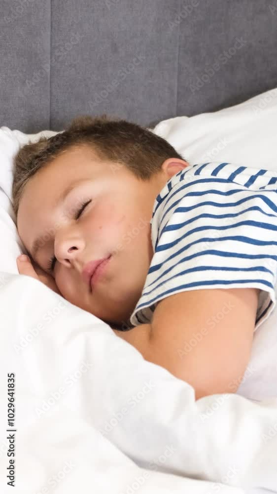 Cute boy falls asleep in bed on white bed linen. A child's dream. Cute boy falls asleep in bed on white bed linen. A child's dream.