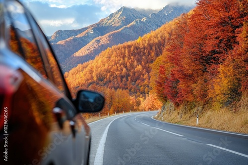 a car driving down a road in front of a mountain photo