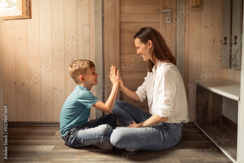 Family, mother and child giving high five at home, bonding, support , achievement. Parent motivating kid  congratulating, child development encouragement concept 