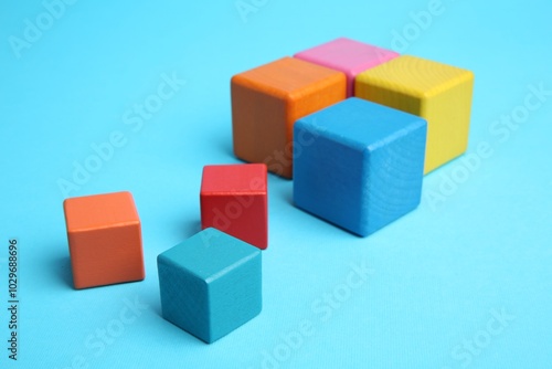 Many colorful cubes on light blue background