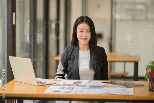 Asian business woman happily working at the office