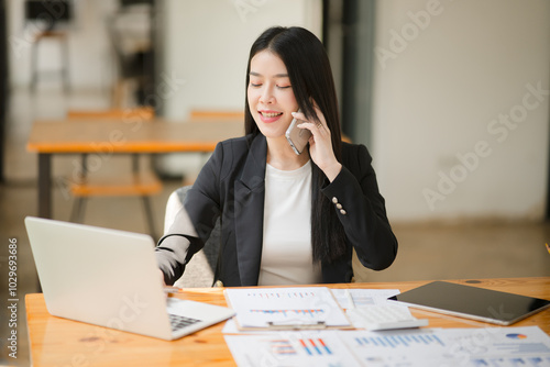 Asian businesswoman talking on the phone, discussing consulting work, explaining about work to a client.