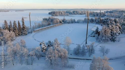 Aerial view tilting away from the Vainolanniemi stadion, winter in Kuopio, Finland photo