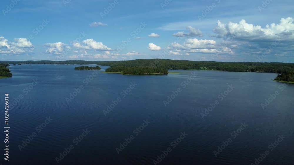 Low flyover: Large blue lake in northern forest park in Finland Low flyover: Large blue lake in northern forest park in Finland