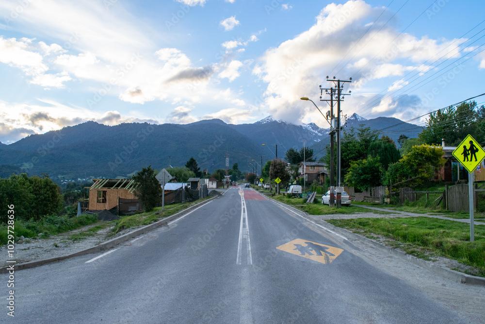 Empty road leading to the mountains in a cloudy day in a small village in chile Empty road leading to the mountains in a cloudy day in a small village in chile