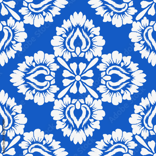A vibrant blue background features intricate white floral patterns arranged in a symmetrical design, creating a striking visual impact.