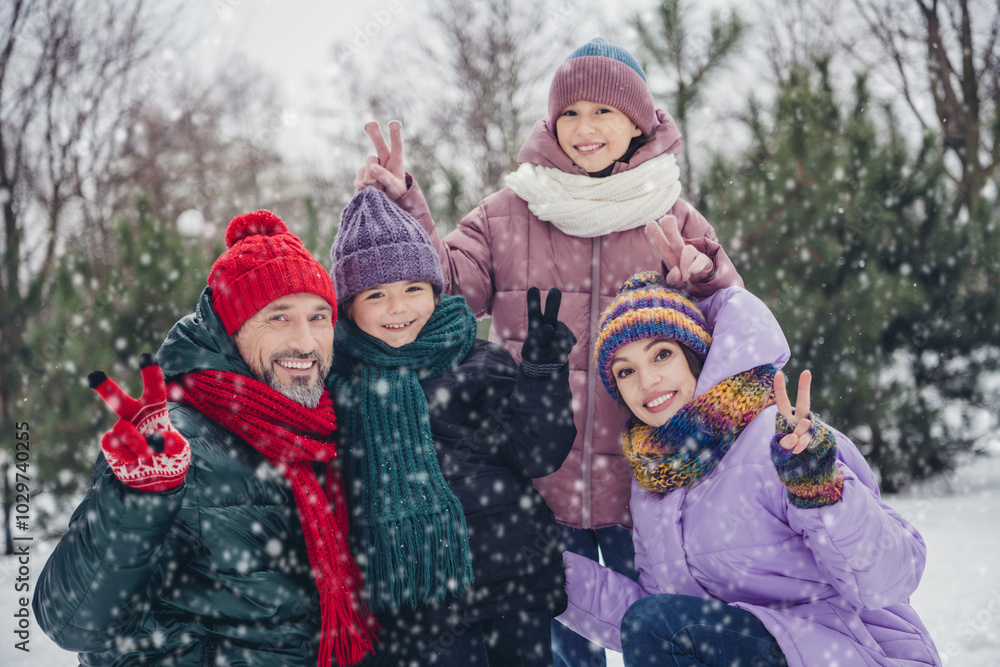 Photo of positive funky little child wife husband dressed coats showing v-signs having fun together outdoors urban forest park Photo of positive funky little child wife husband dressed coats showing v-signs having fun together outdoors urban forest park