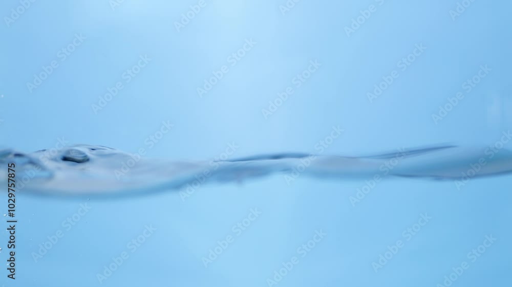 Artistic close-up of blue water waves in slow motion, depicting the freshness and purity of drinking water, suitable for eco-friendly and hydration concepts. Artistic close-up of blue water waves in slow motion, depicting the freshness and purity of drinking water, suitable for eco-friendly and hydration concepts.