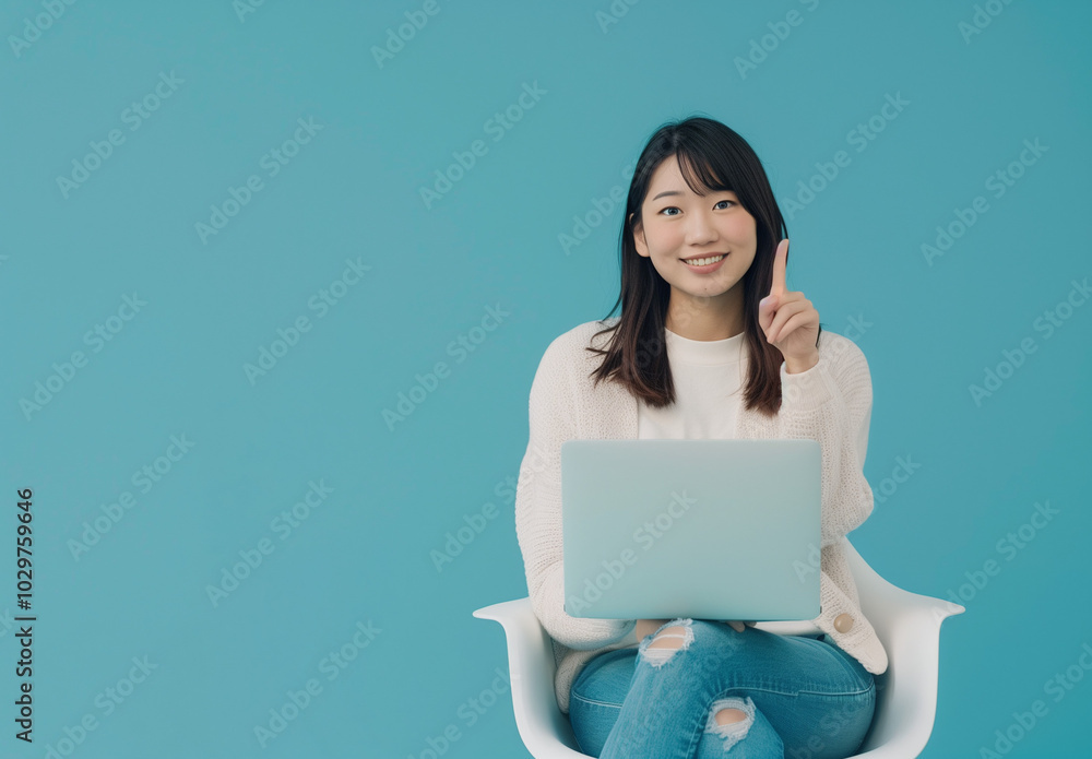 A woman holding a notebook sitting on a chair A woman holding a notebook sitting on a chair