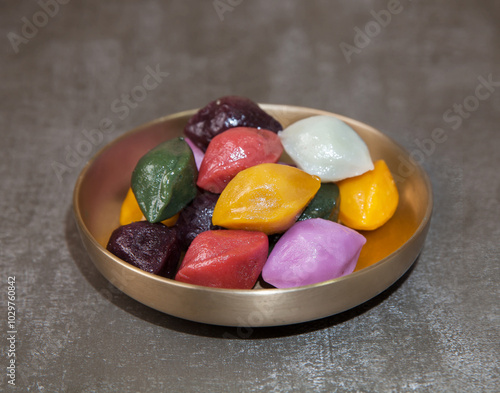 Colorful Songpyeon(half-moon-shaped rice cake) in a dish. Songpyeon is a Korean traditional food eaten during New Year's Day or Korean Thanks Giving Day. photo