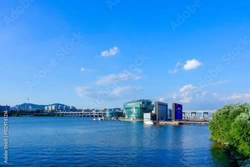 Seocho-gu, Seoul, Korea - August 24, 2019: Yevit Island and Sebit Floating Island on Han River against Banpo Bridge and N Seoul Tower photo