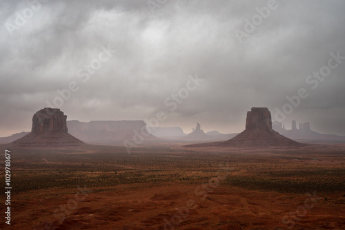 Monument Valley with mist with sandstone buttes seen on Navajo land in Arizona photo