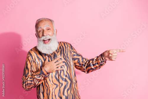 Photo of funny grandfather laugh point finger empty space tiger print shirt isolated on pink color background