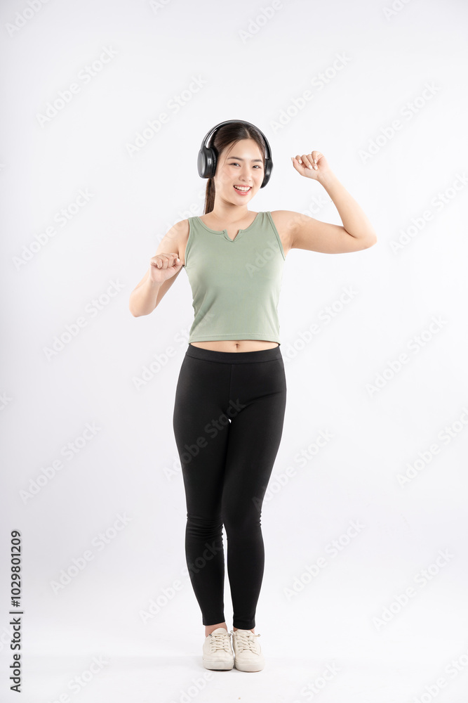 Full body image of young Asian girl wearing sports outfit and posing on white background Full body image of young Asian girl wearing sports outfit and posing on white background