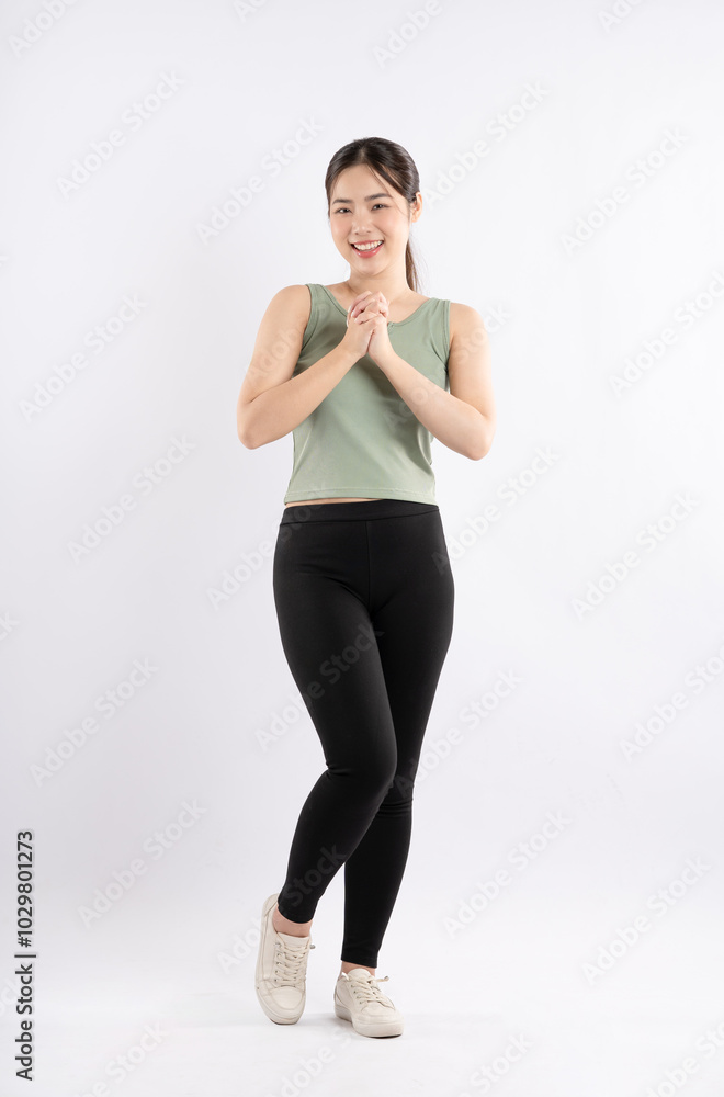 Full body image of young Asian girl wearing sports outfit and posing on white background Full body image of young Asian girl wearing sports outfit and posing on white background