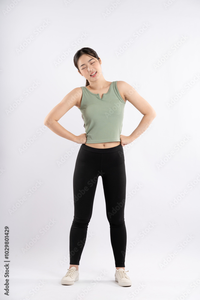 Full body image of young Asian girl wearing sports outfit and posing on white background Full body image of young Asian girl wearing sports outfit and posing on white background