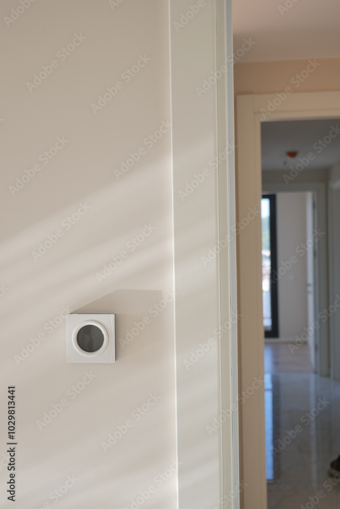 Smart Thermostat on White Wall for Optimal Home Temperature Control Smart Thermostat on White Wall for Optimal Home Temperature Control