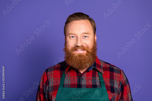 Photo of handsome mature man gardener wear red plaid shirt green apron isolated on purple color background