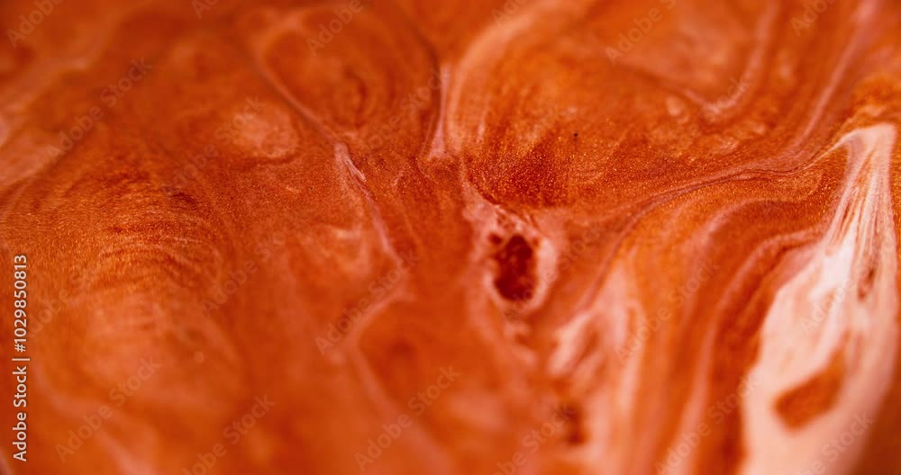 Glitter fluid texture. Paint flow. Defocused orange golden white color glowing shimmering ink spill wave motion abstract art background. Glitter fluid texture. Paint flow. Defocused orange golden white color glowing shimmering ink spill wave motion abstract art background.