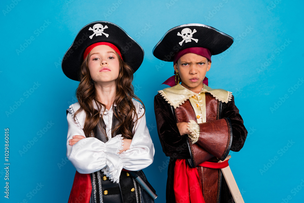 Fototapeta premium Photo of two serious small kids halloween pirate costume crossed arms isolated on blue color background